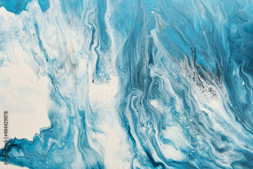 Fluid Art. Liquid white and blue abstract paint drips and wave. Marble effect background or texture