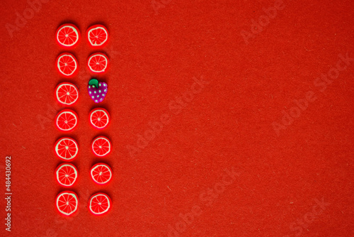 miniature fruits and berries on a red or crimson background  © sorokinsamara