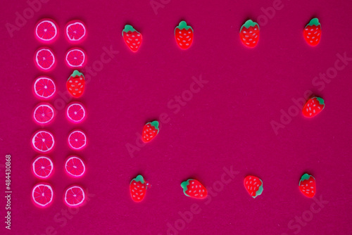 miniature fruits and berries on a red or crimson background 