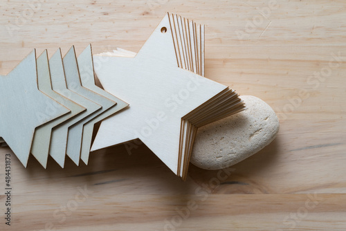 pile of wooden star ornaments or shapes and stone on wood