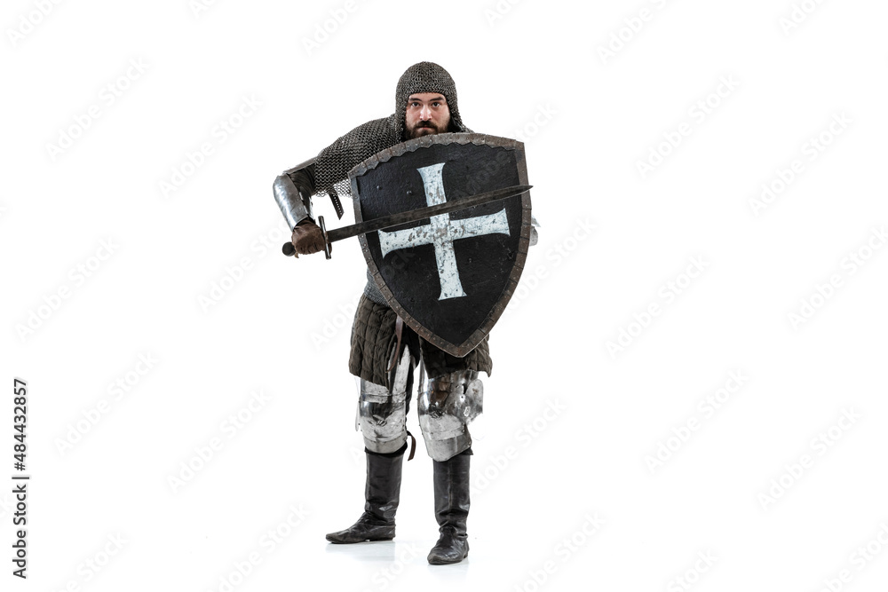 Portrait of fearless warrior chain mail with sword and shield ready to attack isolated over white studio background