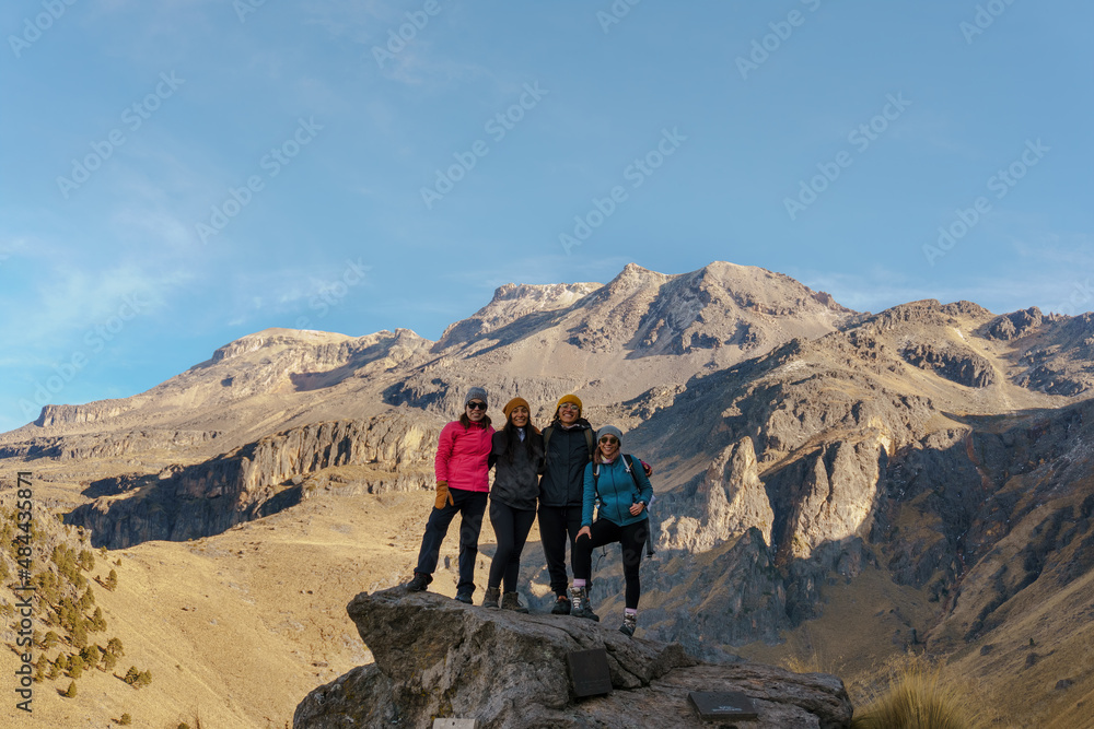 Group of young Latin women hiking trips on mountain vacation, wild adventure. Background for travel concept.