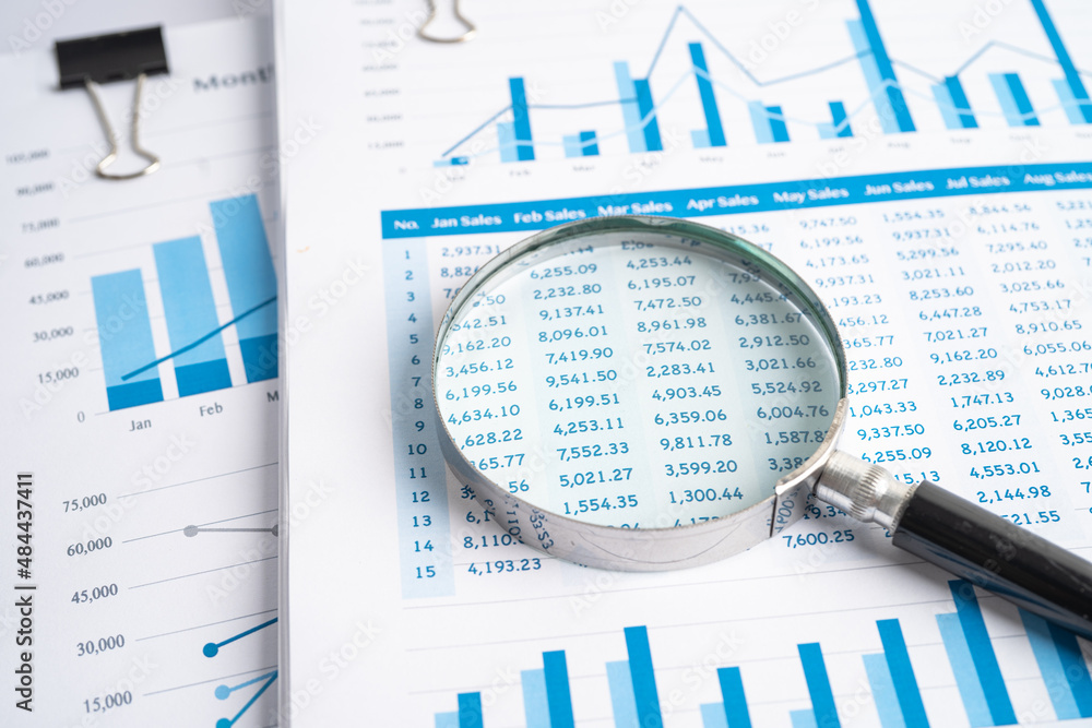 Obraz premium Magnifying glass on charts graphs paper. Financial development, Banking Account, Statistics, Investment Analytic research data economy, Stock exchange trading, Business office company meeting concept.