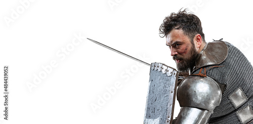 Flyer with courage medieval warrior, knight in special armor protecting himself with shield and sword isolated over white studio background