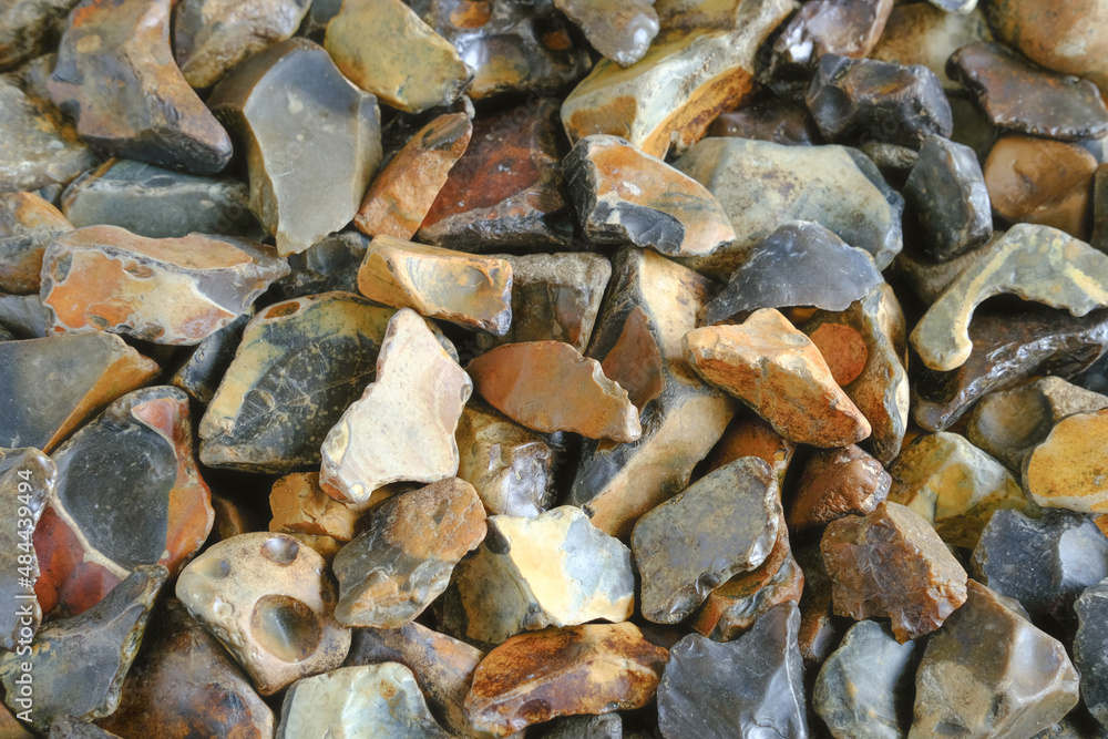 A closeup of knapped fild flint stones pebbes background. A closeup of knapped fild flint stones pebbes background.