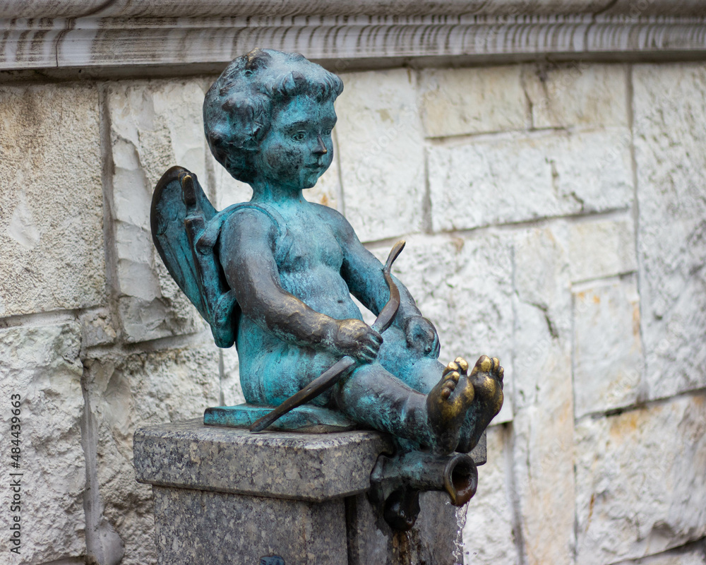 Statue of cupid boy, eros fountain. Love angel sculpture
