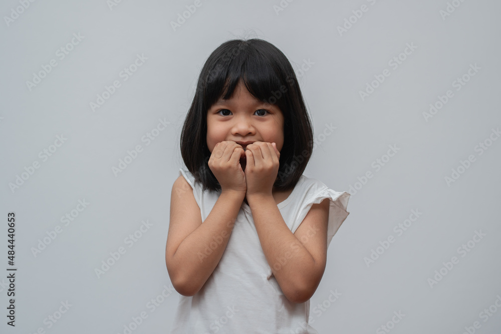 Portrait of happy and funny Asian child girl on white background, a child looking at camera. Preschool kid dreaming fill with energy feeling healthy and good concept Portrait of happy and funny Asian child girl on white background, a child looking at camera. Preschool kid dreaming fill with energy feeling healthy and good concept