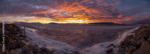 Sunset panoramic at Utah Lake in winter with ice and camera