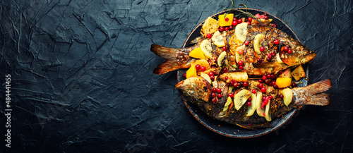 Baked carp with fruits, space for text