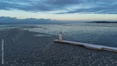 Beautiful sunset over Sodus Point Lighthouse the frozen Lake Ontario photo