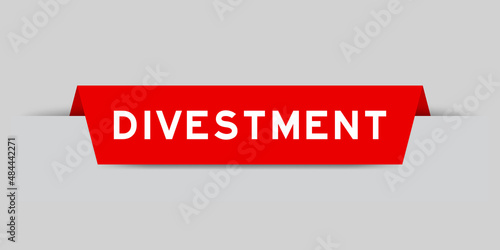Red color inserted label with word divestment on gray background