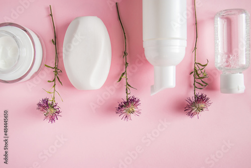 Cosmetic products on pink background. Spa accessories  body care. Wellness concept.