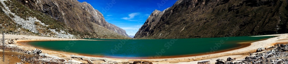 Panorama of mountains and glacial lake in the Cordillera Blanca Mountain range along the Santa Cruz Trek near Huaraz in Peru.