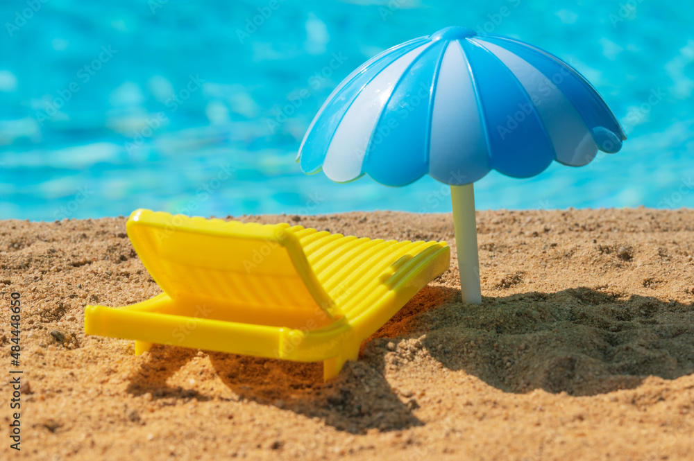 The yellow sunbet and an umbrella on the beach The yellow sunbet and an umbrella on the beach