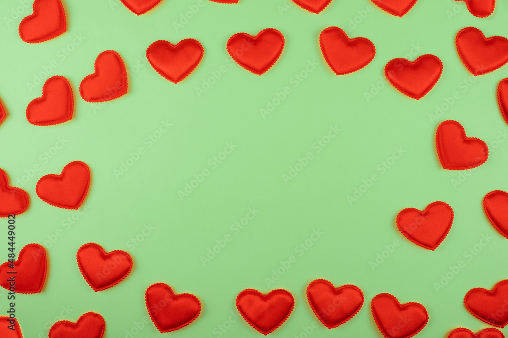 Valentine day green paper background with red hearts background. Valentines day or love concept, copy space