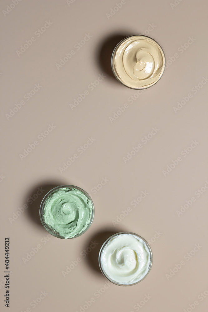 Set facial clay green yellow white mask on pastel beige background with copy space. Beauty concept. Set facial clay green yellow white mask on pastel beige background with copy space. Beauty concept.