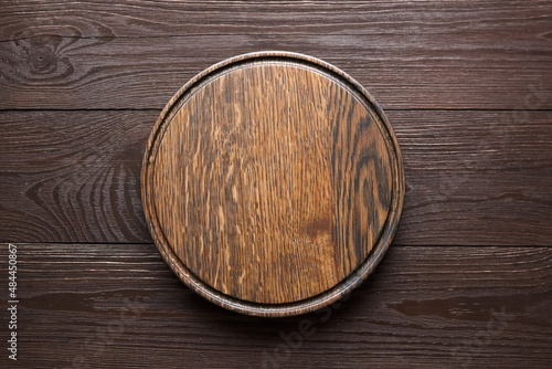 Obraz na plátně Round cutting board with groove on wooden table