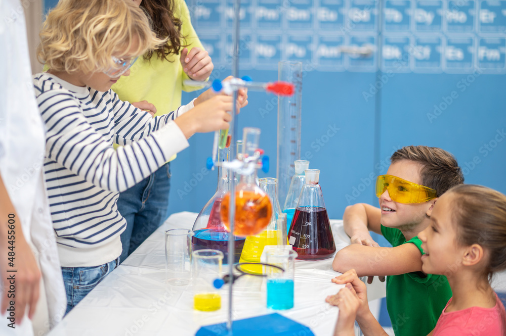 Children doing chemical experiment in chemistry class Children doing chemical experiment in chemistry class
