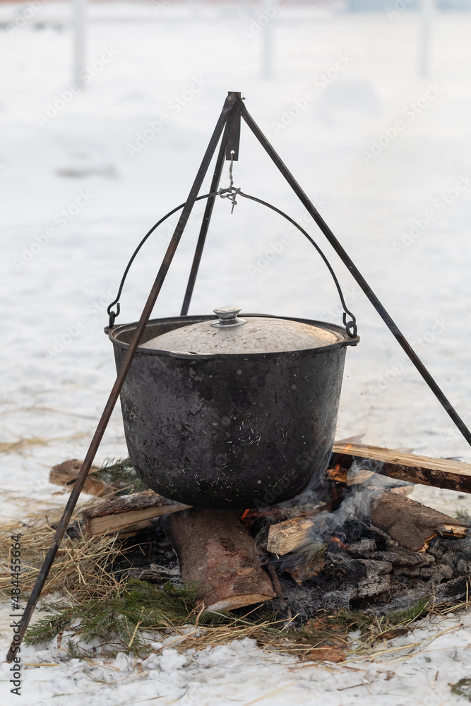 Cooking in camping conditions in a boiler on a fire outside in winter. campfire. nobody Cooking in camping conditions in a boiler on a fire outside in winter. campfire. nobody
