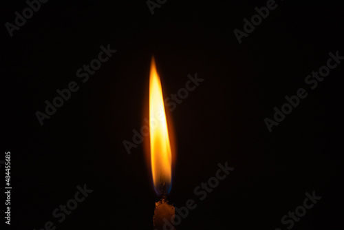 Burning candle, smoke on a dark background.