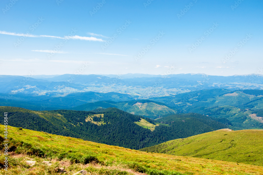beautiful, summer slopes of mountains covered with green young grass against the blue sky, travel. High quality photo