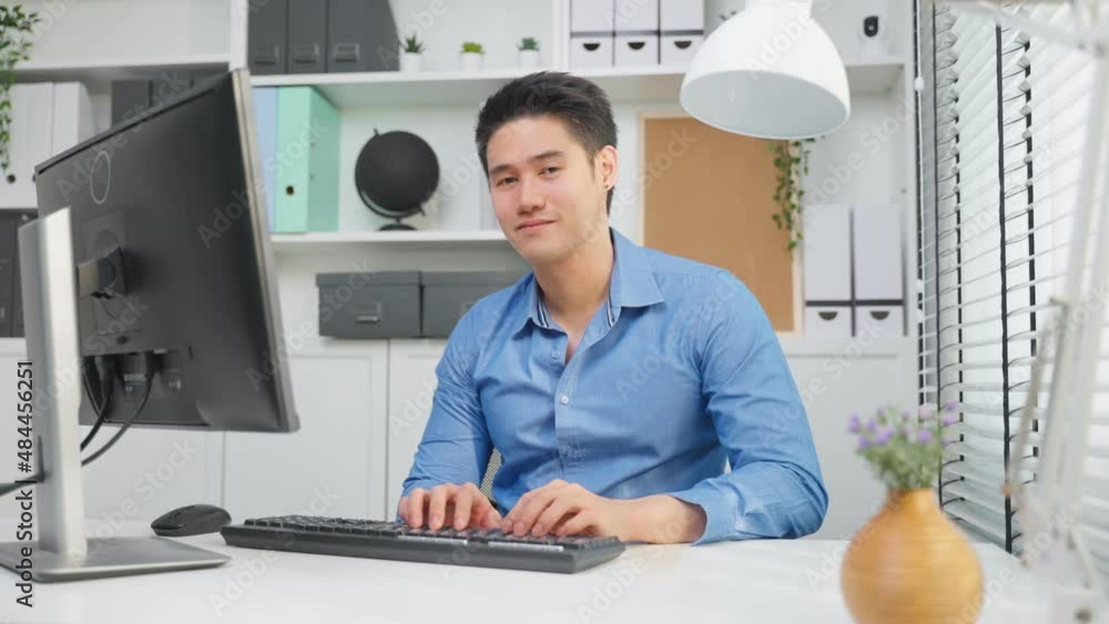 Portrait of Asian business man using laptop computer working in office Portrait of Asian business man using laptop computer working in office