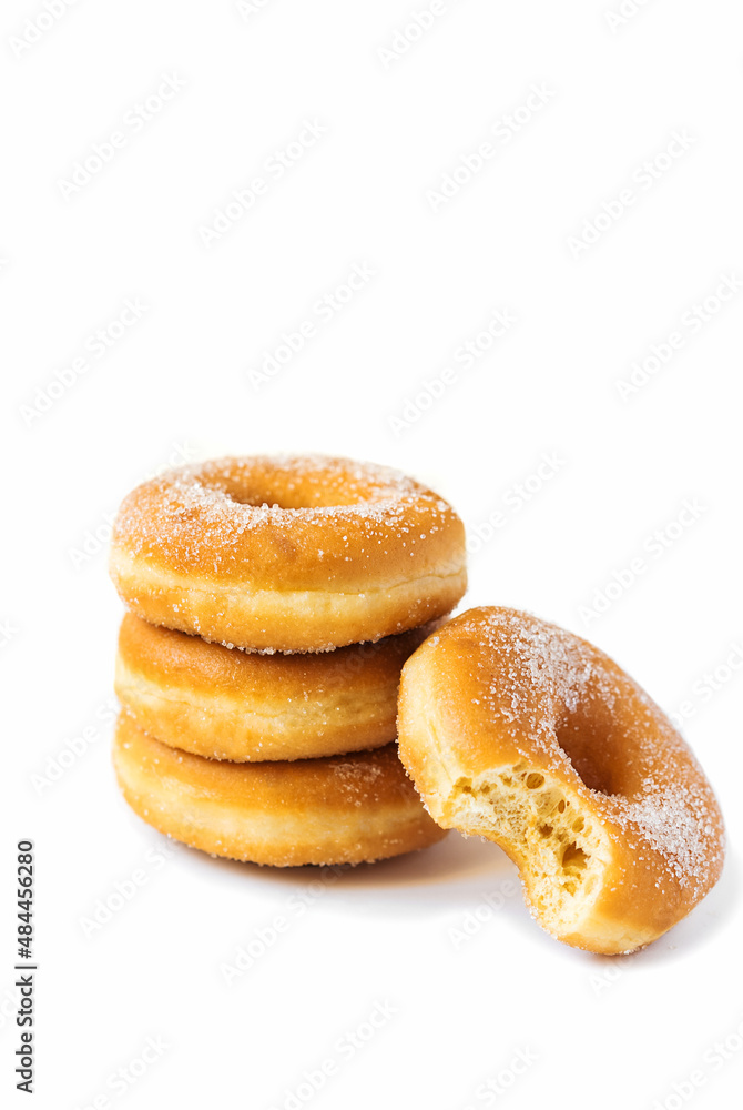 Isolated doughnuts, one of them is bitten Isolated doughnuts, one of them is bitten