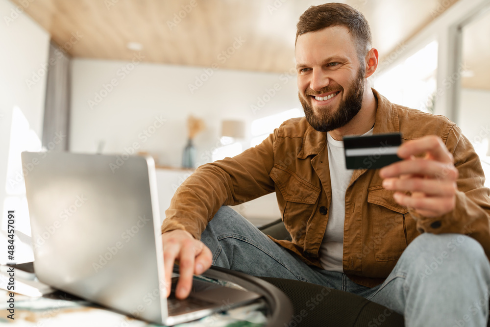 Happy Man Shopping Online Using Laptop And Credit Card Indoor Happy Man Shopping Online Using Laptop And Credit Card Indoor
