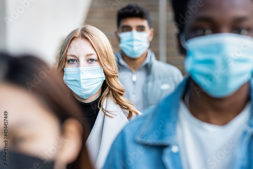 Multiracial people in the city wearing face mask photo