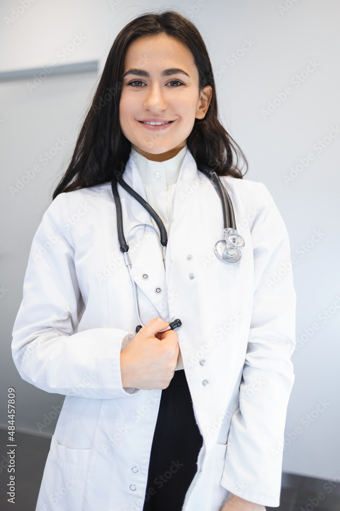 Portrait of attractive young female doctor in white medical coat Portrait of attractive young female doctor in white medical coat