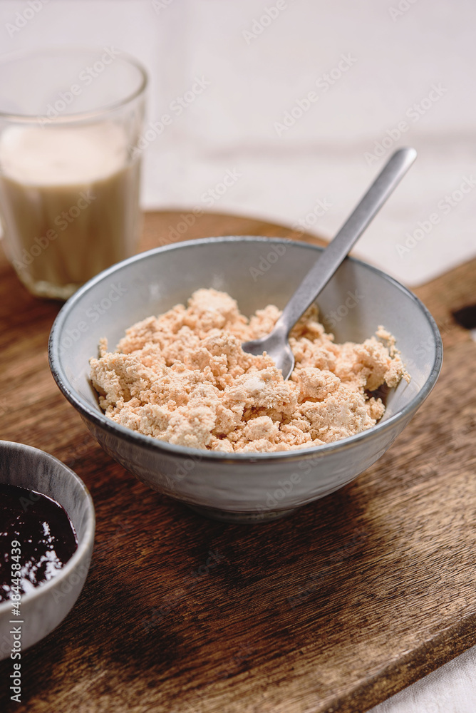 Homemade melted cheese curd served with baked milk and jam on wooden cutboard. Healthy breakfast. Haze effect. Selective focus Homemade melted cheese curd served with baked milk and jam on wooden cutboard. Healthy breakfast. Haze effect. Selective focus