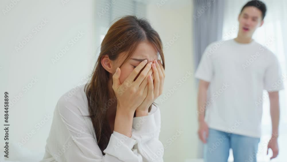 Asian young couple sitting on bed with painful after fight argument. Asian young couple sitting on bed with painful after fight argument.