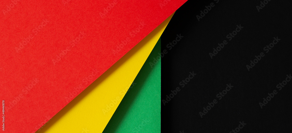 Black History Month color background. African American history month celebration. Abstract red, yellow, green color flag on black paper background - obrazy, fototapety, plakaty 