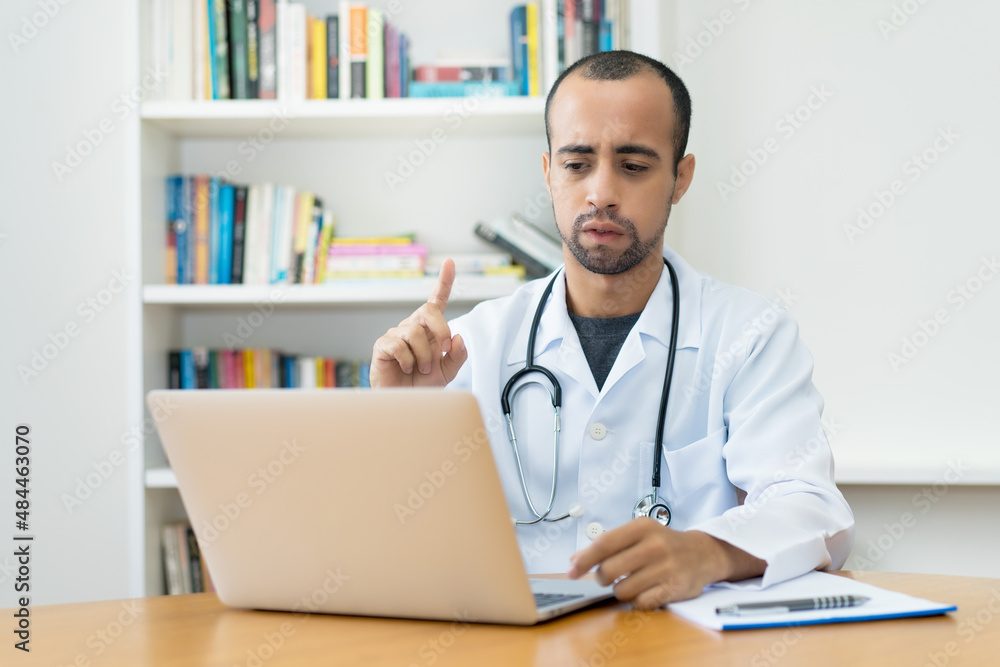 Latin american doctor warning patient at video call Latin american doctor warning patient at video call