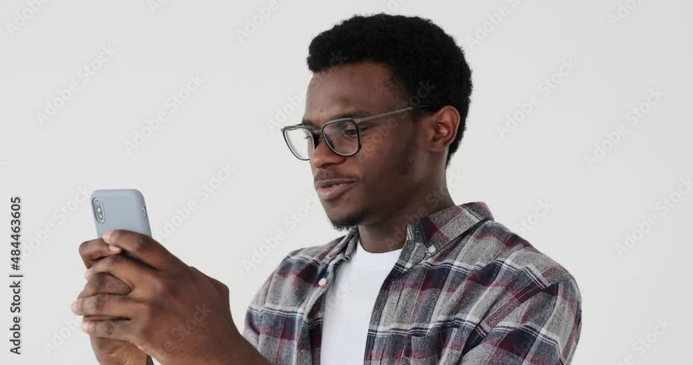 Happy man text messaging on mobile phone over white background Happy man text messaging on mobile phone over white background