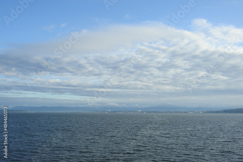 The picturesque scenery of the Puget Sound, with Everett Washington, and the snow covered North Cascades Mountains in the distance. 