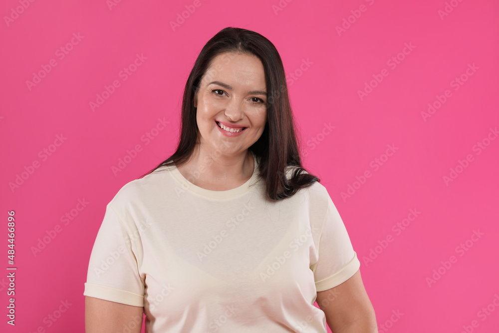 Beautiful overweight woman with charming smile on pink background Beautiful overweight woman with charming smile on pink background