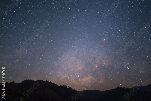 The Milky Way rising in the sky with meteor above the silhouette mountains at Mae Hong Son province Northern Thailand.