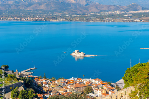 View from the ruins of the ancient hilltop Fortress of Palamidi, looking down on the Bourtzi Castle in the Argolic Gulf of the Aegean Sea, and the Naplion Old Town, in Nafplio, Nafplion, Greece.