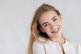 beautiful young blondes girl showing her dental braces