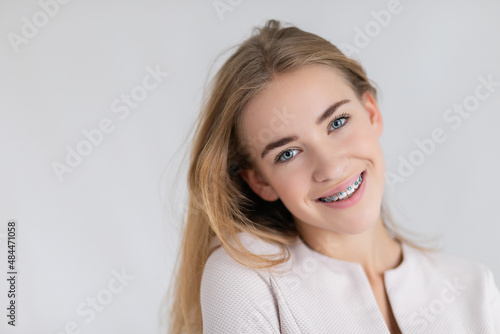 beautiful young blondes girl showing her dental braces