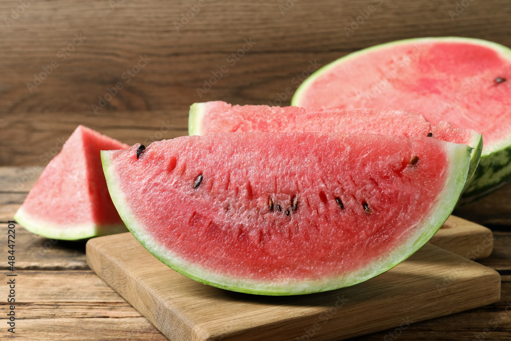 Slices of tasty ripe watermelon on wooden table Slices of tasty ripe watermelon on wooden table