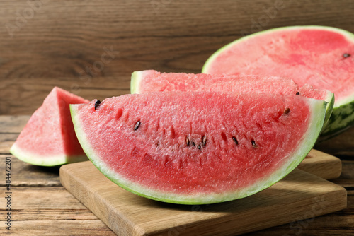 Slices of tasty ripe watermelon on wooden table