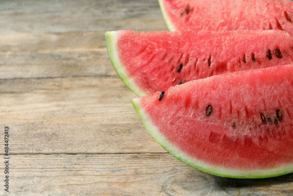 Slices of tasty ripe watermelon on wooden table, closeup. Space for text Slices of tasty ripe watermelon on wooden table, closeup. Space for text