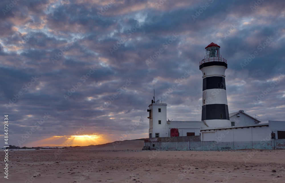 Cape Recife Lighthouse at sunset on dramatic cloudy sky evening in Port Elizabeth