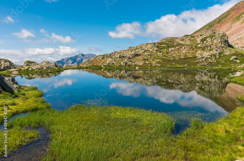 Escena de reflejos sobre el embalse de Pozo de las Lomas en la montaña palentina photo