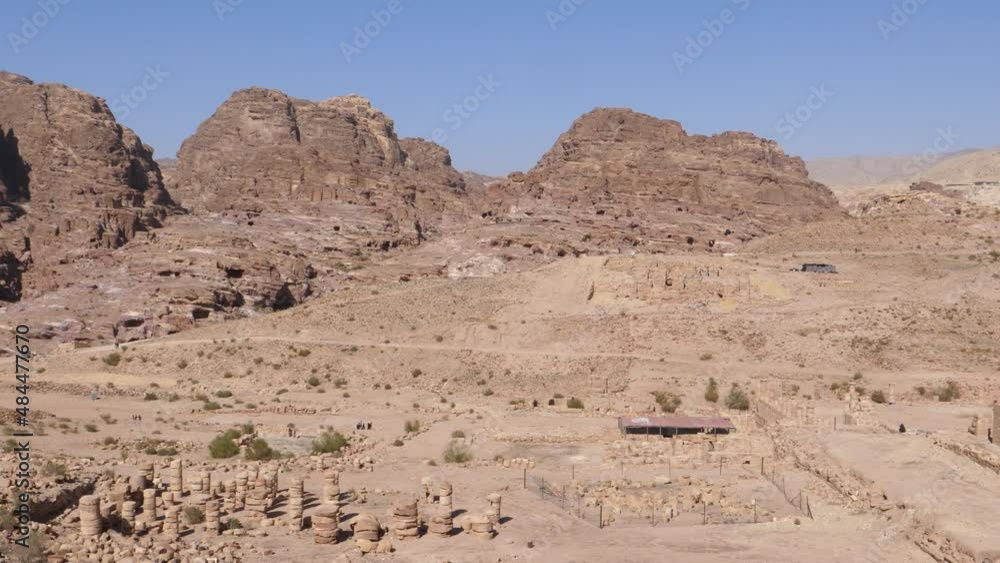 Panoramic view of Petra archeological park UNESCO world heritage. Dry mountains rocky landscape and old ancient ruins during sunny hot day Panoramic view of Petra archeological park UNESCO world heritage. Dry mountains rocky landscape and old ancient ruins during sunny hot day