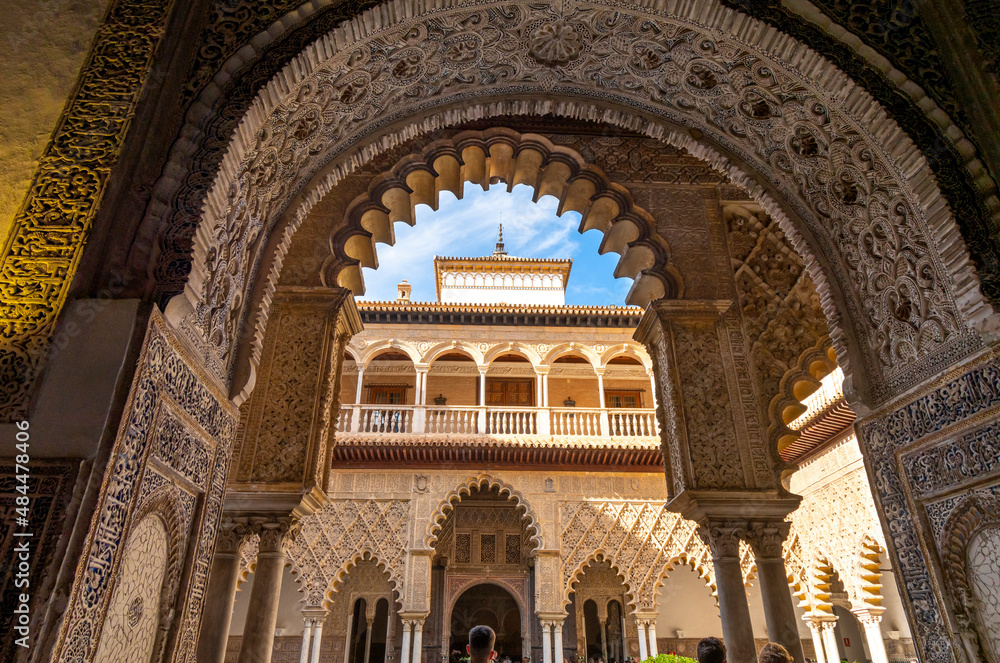 Interior archways, porticos and columns in the courtyard of the Royal Alcazar in Seville, Spain.