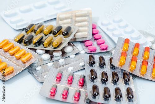 Tablets and medical capsules in a blister pack isolated on white background