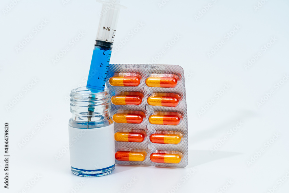 Medical glass jar with syringe and pills isolated on white background. Medicine Medical glass jar with syringe and pills isolated on white background. Medicine